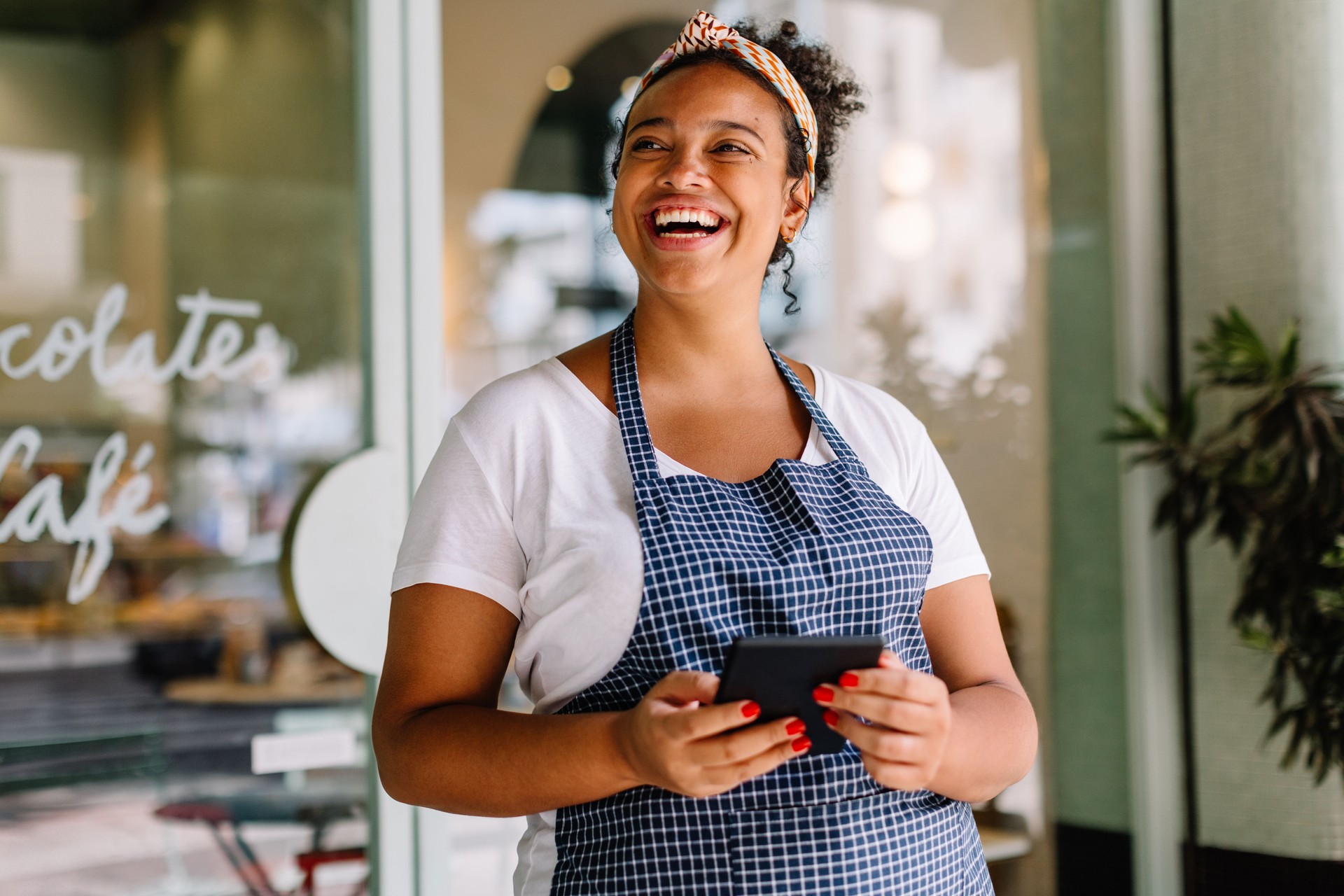 Successful entrepreneur in a coffee shop using a tablet pc